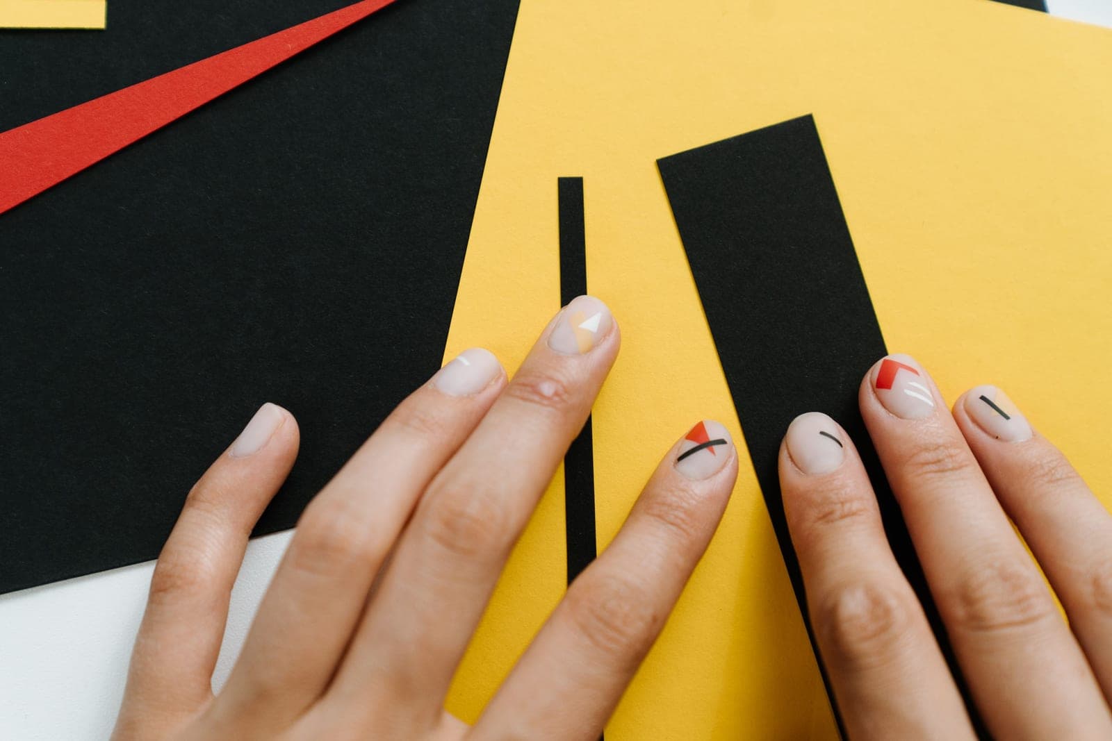 Long coffin-shaped nails photographed against a plain background