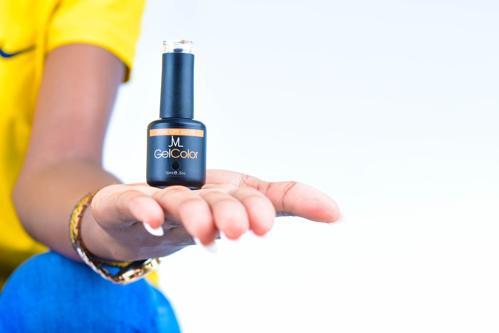 A bottle of clear base coat used for manicure preparation