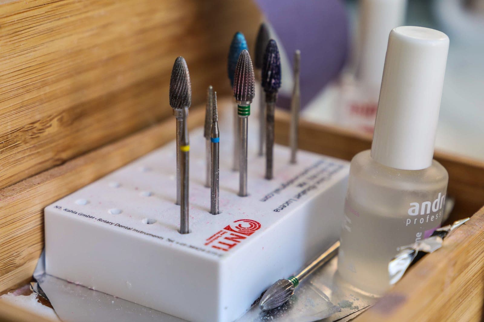 A set of nail drill bits laid out on a surface